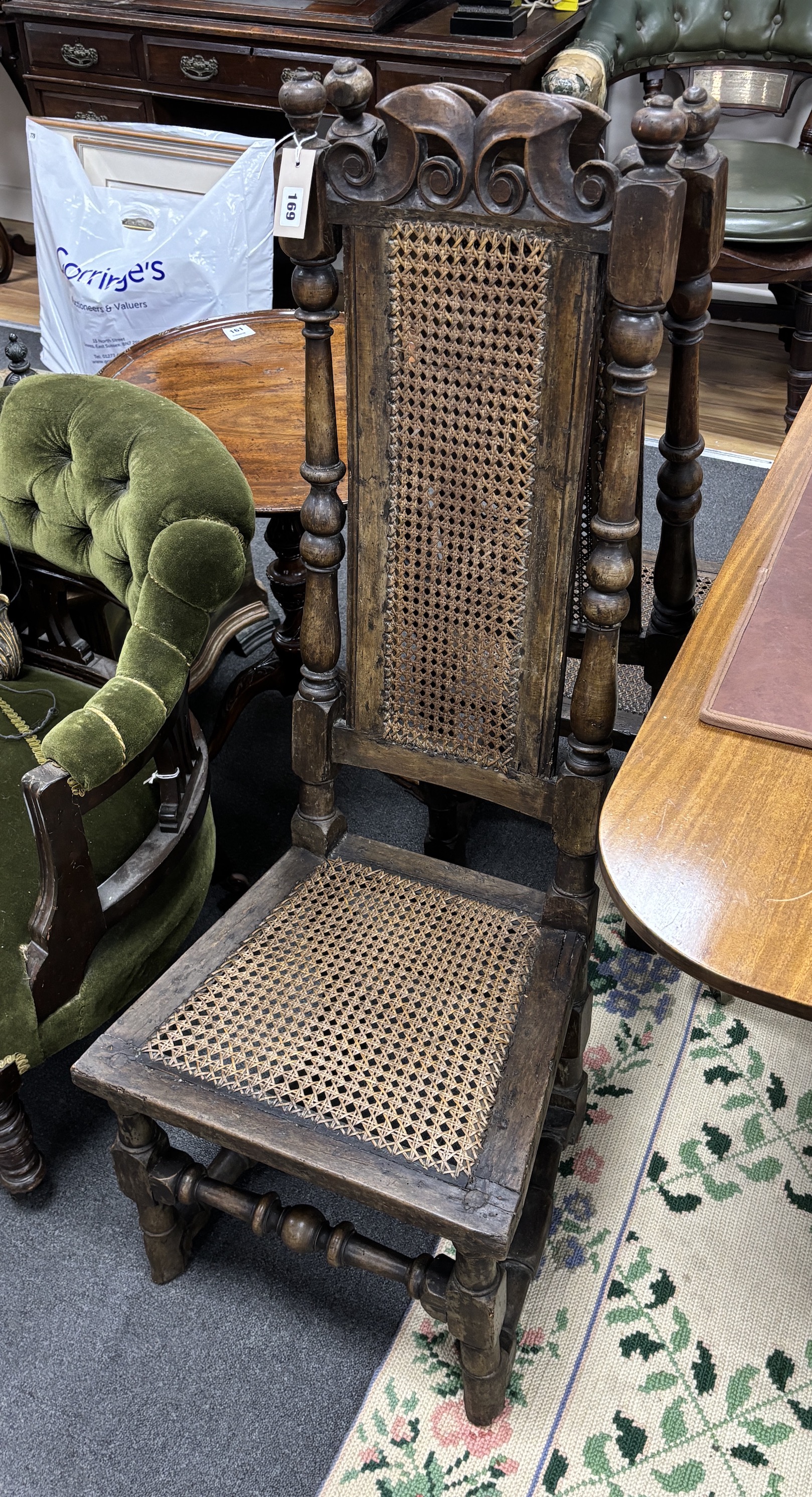 A pair of late 17th century walnut and caned high back dining chairs, height 116cm